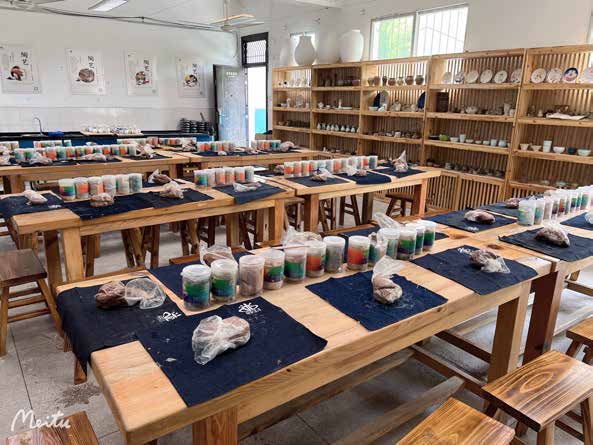 陶艺教室中整齐布置的教学桌、材料工具与作品陈列架
